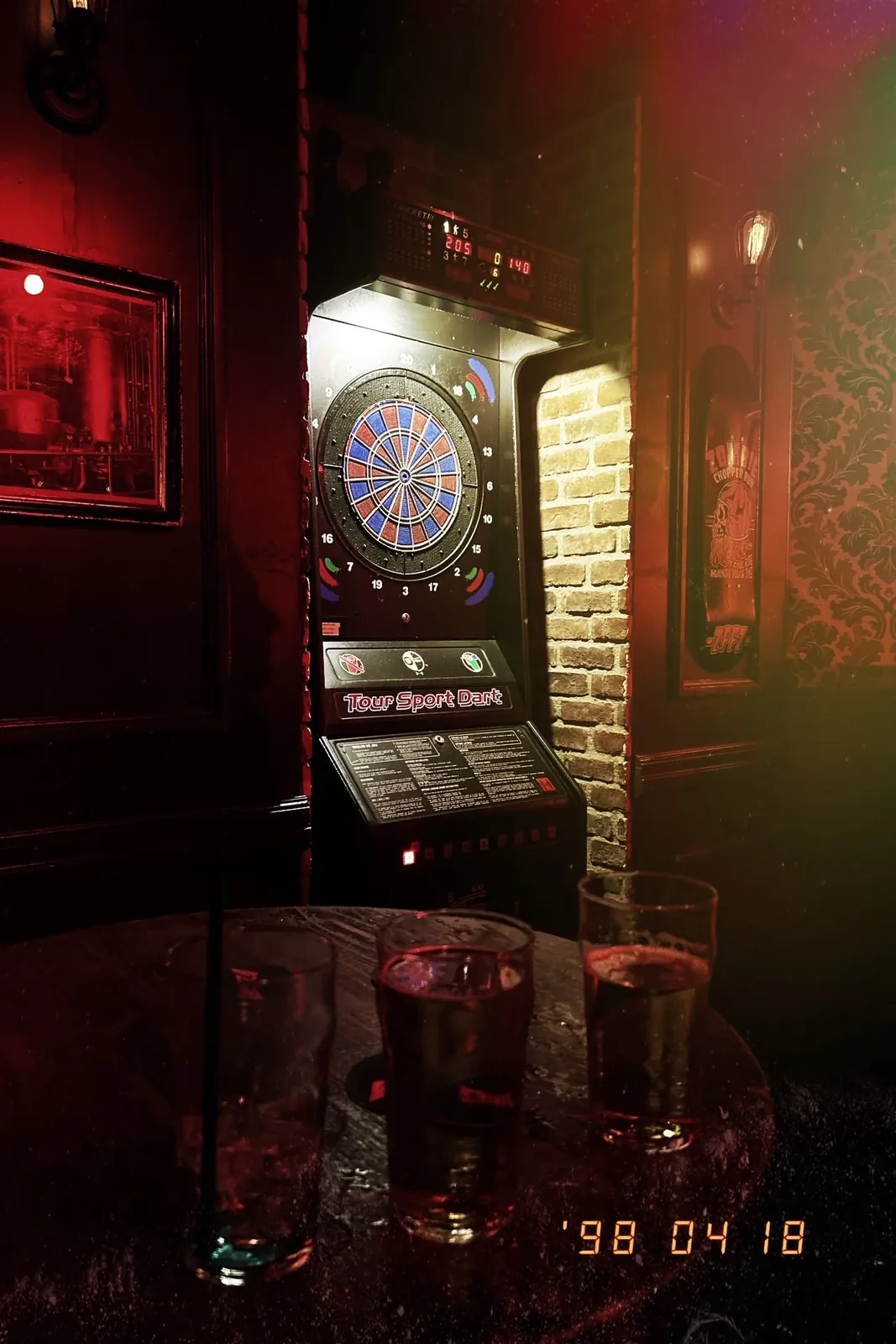 La cible de fléchettes du pub, éclairée dans la pénombre